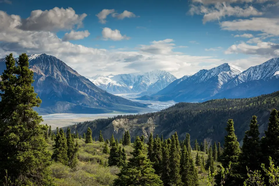 Mountain peaks rising into a clouded sky