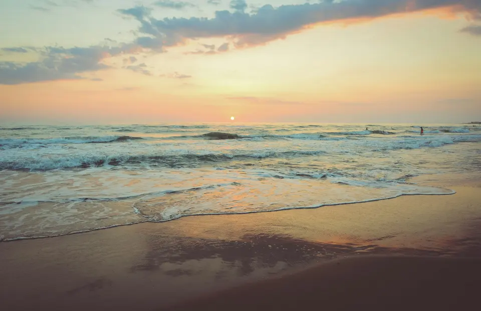 A calm coastal scene in soft evening light